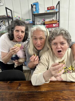 Three ladies eating cookies at Star of Hope